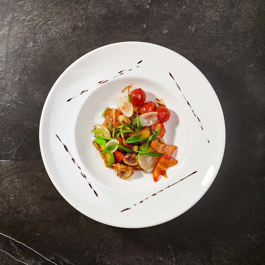 Vegetables in sweet and sour sauce sprinkled with fresh herbs